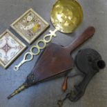 A cast iron marmalade cutter, fire bellows, brass skimmer and tiles