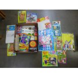 A box containing various vintage childhood toys on display cards
