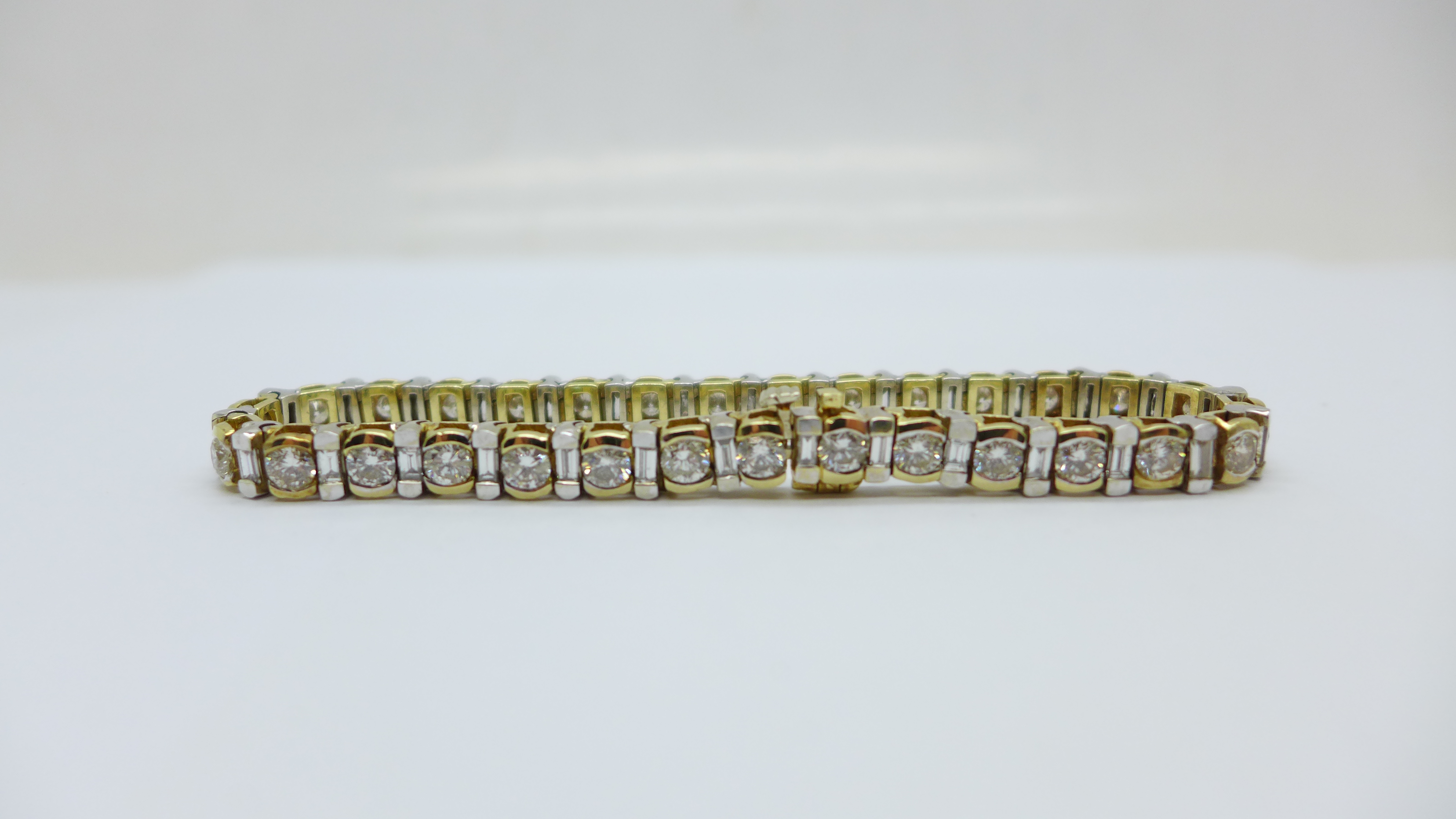 A 14k gold and diamond tennis bracelet with sixty diamonds, approximately 7ct diamond weight, 21.4g - Image 3 of 6