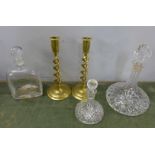 Three decanters and a pair of brass open twist candlesticks