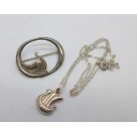 A silver Viking ship brooch and a silver Viking ship pendant and chain, 5.5g