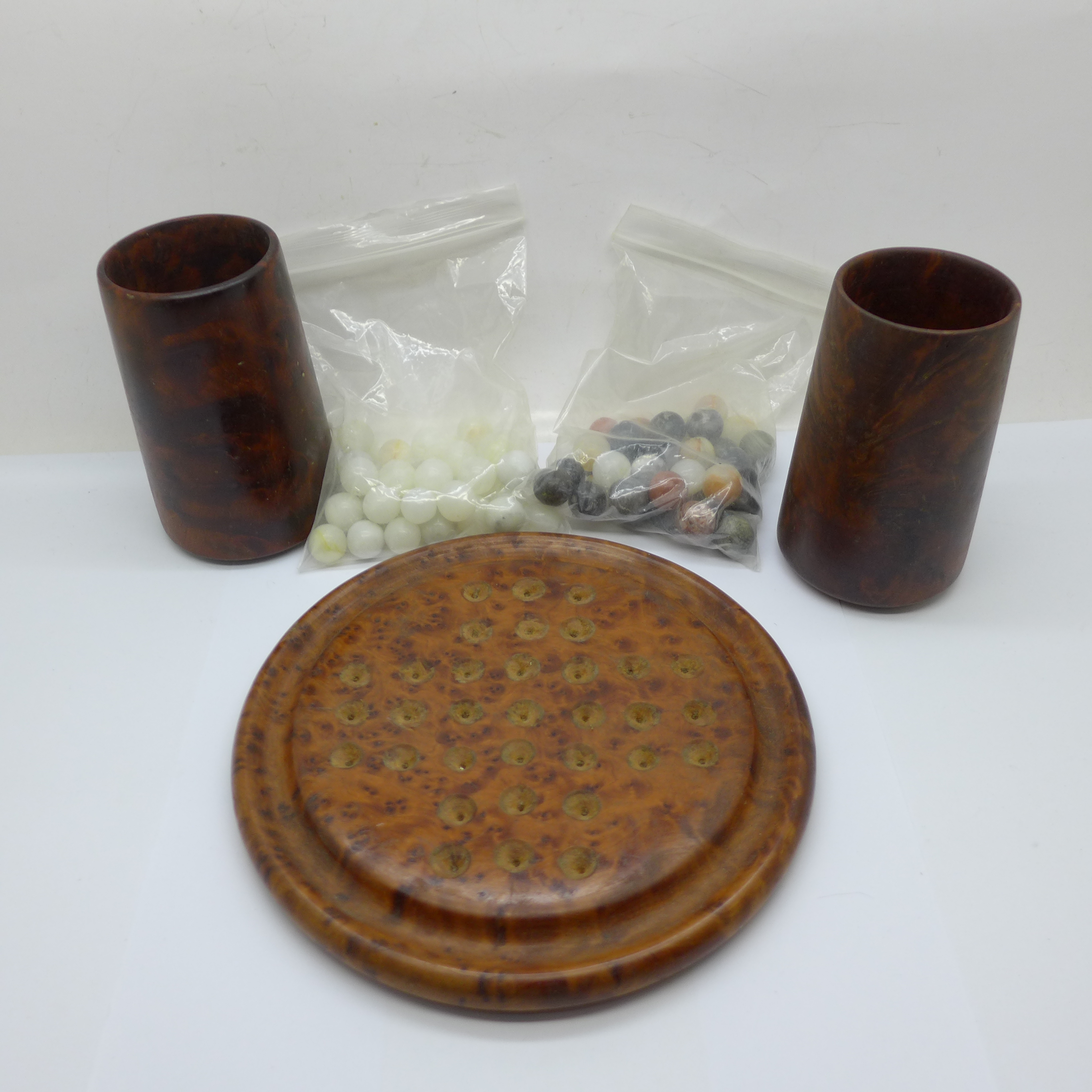 A thuya wood solitaire set with two sets of natural stone marbles and two dice cups