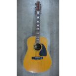 A Kimbara twelve string acoustic guitar (lacking six strings)