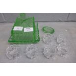 A green glass butter dish and a set of six crystal napkin rings and an ashtray