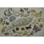 A collection of brooches including a very large peacock brooch, lizards, butterflies, etc.