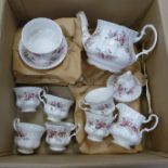 A Royal Albert Lavender tea set including a cake stand, six plates, six cups and saucers, a tea pot,