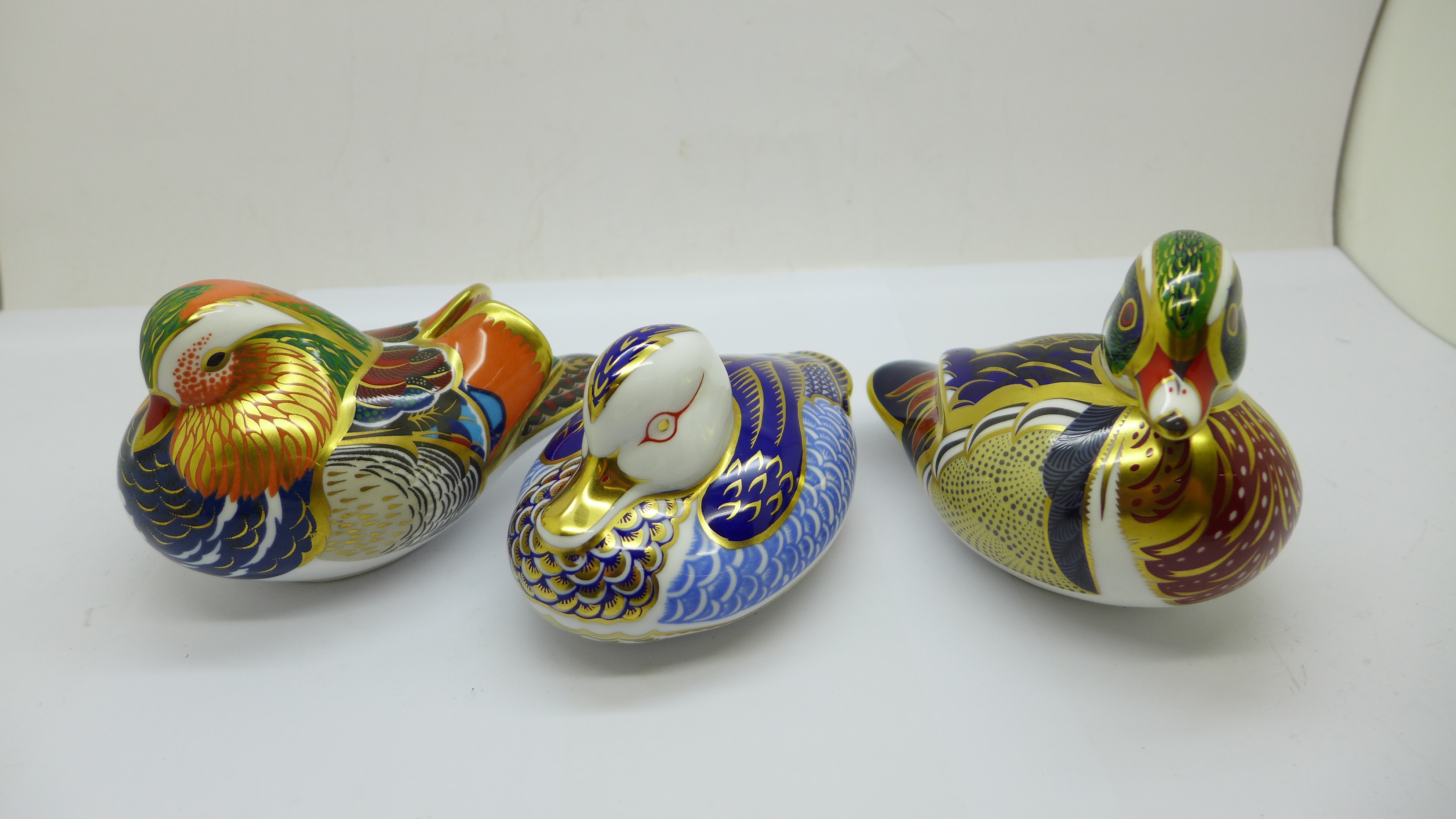 Three Royal Crown Derby paperweights; Mandarin Duck with gold stopper and original box, Carolina