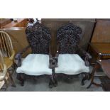 A pair of Burmese style carved hardwood chairs