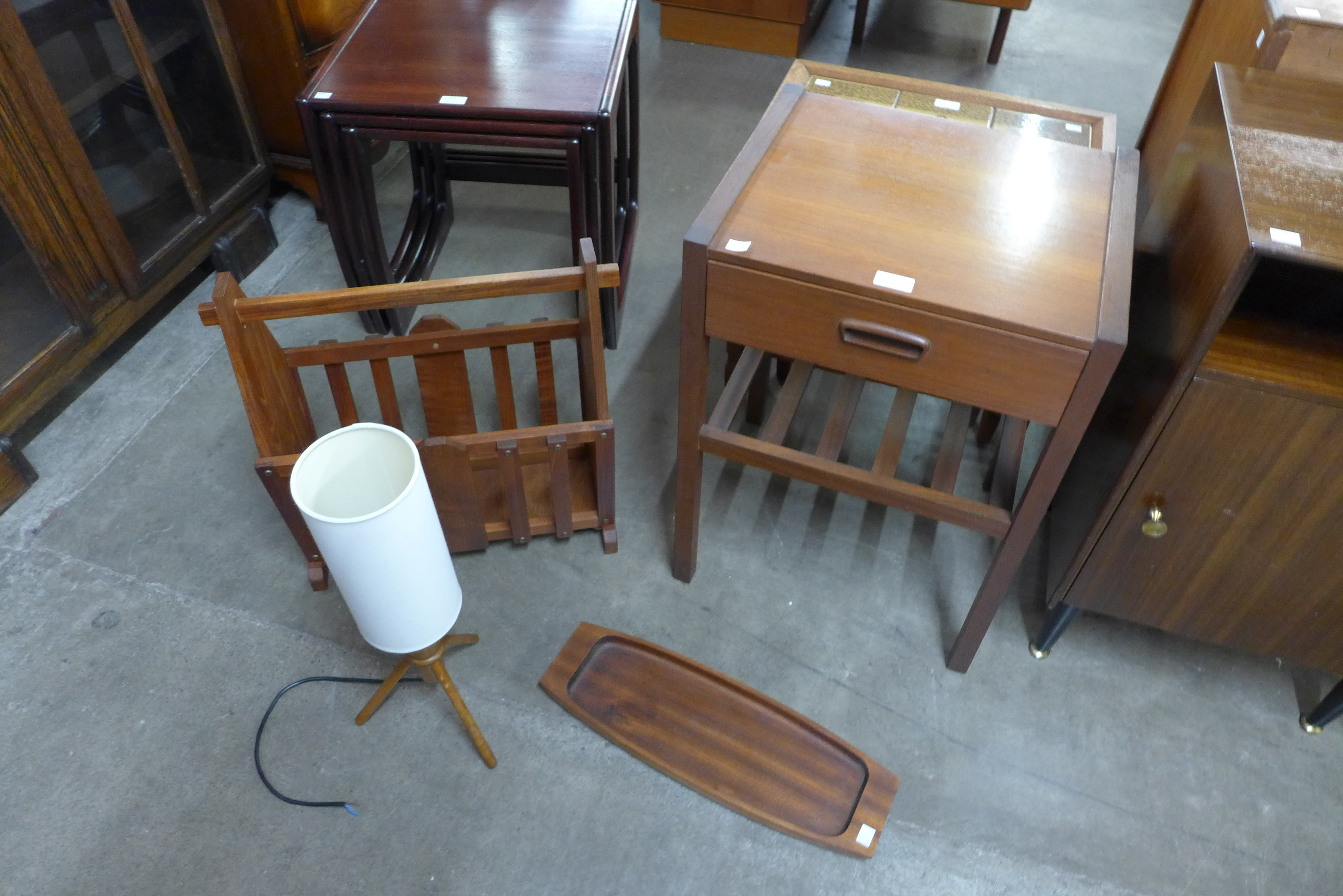 A small teak side table, a tray, table lamp and a magazine rack