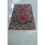 A red ground rug, 180 x 119cms