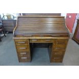 A Victorian oak tambour roll top desk