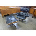 A Charles & Ray Eames style simulated rosewood and black leather revolving lounge chair and