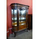 A French Louis XV style bow front mahogany display cabinet