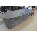 A galvanised slipper bath