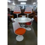 An Arkana style white laminate tulip shaped table and six chairs