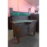 An Arts and Crafts oak, copper and green tiled washstand