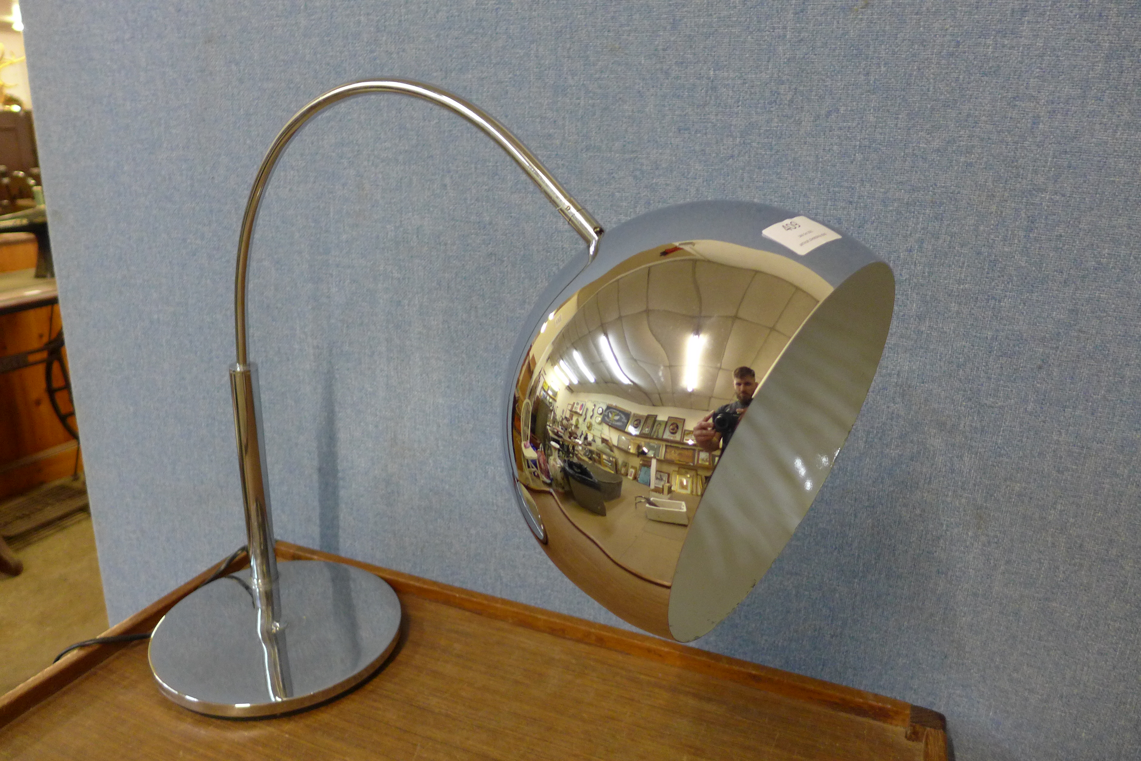 A chrome arc table lamp