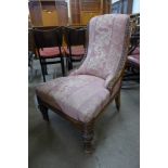 A Victorian carved oak and fabric upholstered lady's chair