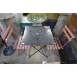 A folding metal garden table and two chairs