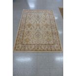 A beige ground rug, 194 x 139cms