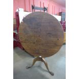 A George III mahogany circular tilt top tripod tea table