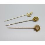 A 15ct gold ruby and diamond set pin and two yellow metal pins
