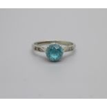 An 18ct white gold and platinum set ring with blue stone and old cut diamond set shoulders, 2.2g, N