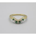 A 9ct gold, diamond and emerald ring, 1.6g, P