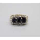 A 9ct gold, twenty-four diamond and three sapphire ring, 2.2g, K