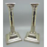 A pair of silver column candlesticks, 23.5cm, one top dented