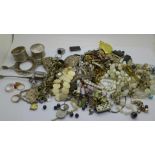 A collection of metal and white metal jewellery and other items including napkin rings, a collection