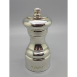 A silver pepper mill