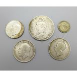 Five coins, a Victorian 1889 crown, a George IV 1825 half-crown, a 1918 half-crown, a 1928