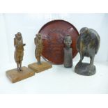 A carved model of a kiwi, a lacquered tray, an African carving and a pair of wooden figures