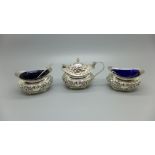 A silver cruet set and two spoons, Birmingham 1906, 117g