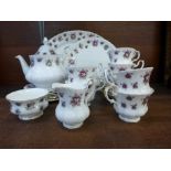 A Royal Albert Sweet Violet six setting tea set with teapot, cream and sugar, cake plate and oval
