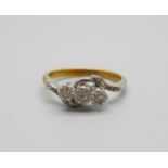 An 18ct gold and platinum set three stone diamond ring, 2.9g, L