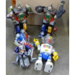 Four plastic toy robots and an action figure