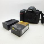 A Nikon D70S camera body, Nikon charger and Nikon battery with carry bag