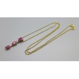 A 9ct gold, diamond and ruby pendant on a 10K gold chain, 3g