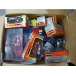 A collection of boxed die-cast model vehicles including Burago, Carrera Evolution Ferrari, sports