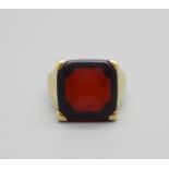 A yellow metal and red stone set ring, tests as 15ct gold, continental control marks on the