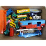 A box of die-cast model vehicles including a VW Beetle, Transporter, Dodge trucks, etc.