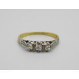 An 18ct gold and three stone diamond ring, 1.7g, M