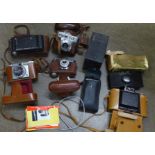 A collection of vintage cameras, including folding, Halina, Voigtlander and Agfa