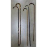 Five walking sticks, one with collar marked 18ct G.P. for gold plated