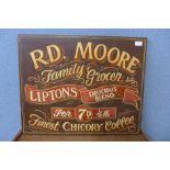 A hand painted wooden sign, R. D Moore, Grocer