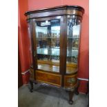 A French Louis XV style bow front mahogany display cabinet