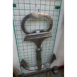 A large chrome anchor wall hanging bottle opener