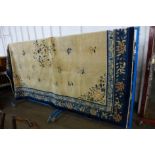 A large Chinese beige ground rug, 275 x 340cms.